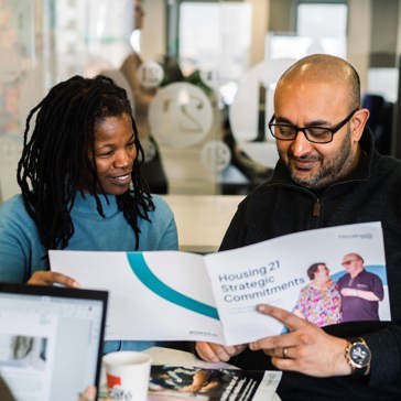 Employees reading Housing 21's Strategic Commitments