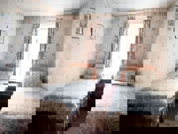 Twin beds in a small bedroom of a residents' apartment