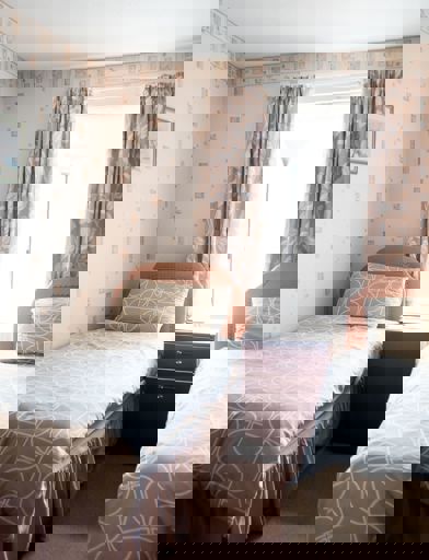 Twin beds in a small bedroom of a residents' apartment