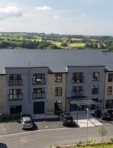 Birds eye view of the front entrance of Bowland View, showing the front and roof of the scheme with a car park