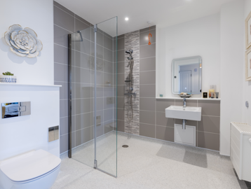 A stylish modern bathroom with wet-room style access in the show apartment