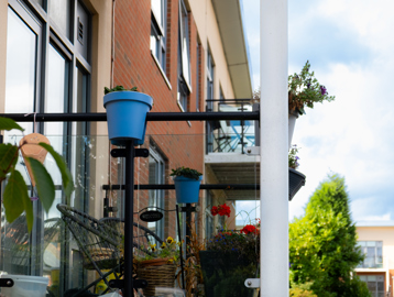 Plants pots and garden furniture on a resident's balcony