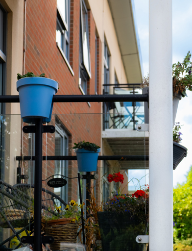 Plants pots and garden furniture on a resident's balcony 