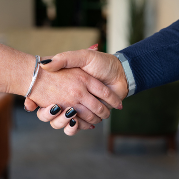 Two business professionals shake hands