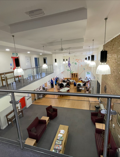 An aerial shot of Green Lane View showing an outdated lounge and communal area decorated with brown and grey interior 