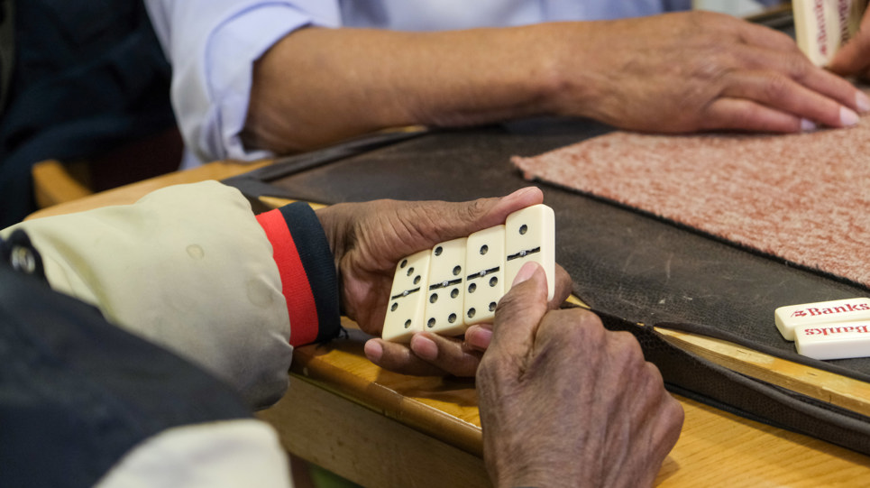 Resident showing their hand playing Dominos