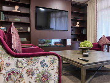 the scheme communal area with a tv and chairs