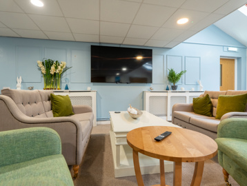 Communal lounge with seating and a TV