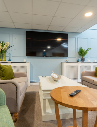 Communal lounge with seating and a TV 