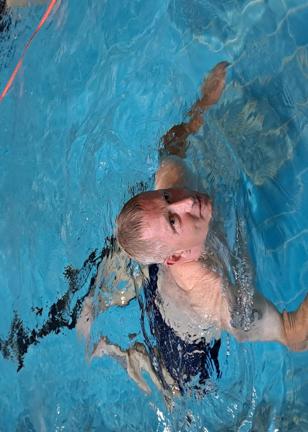 Lee swims in a pool for a sponsored fundraiser