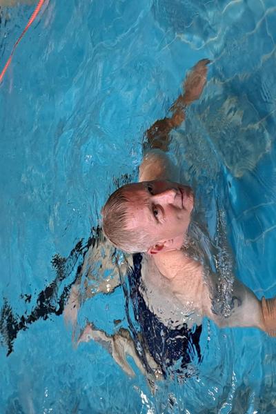 Lee swims in a pool for a sponsored fundraiser
