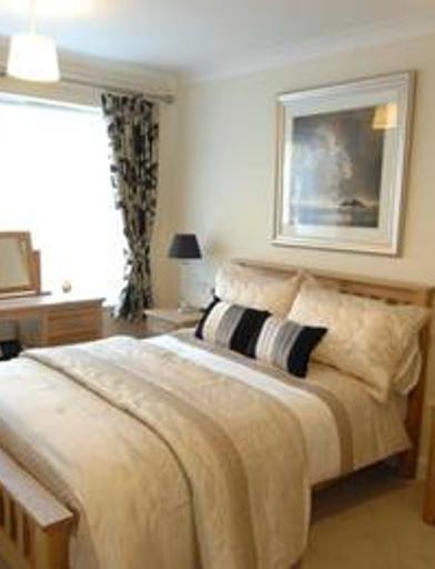 A double bedroom with cream colour scheme