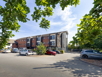 Front outer building of Oakwood Gardens with a car park situated at the front