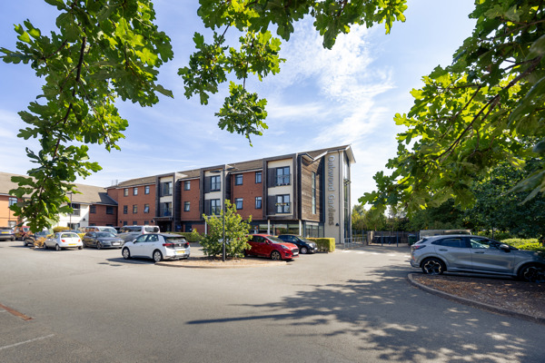 Front outer building of Oakwood Gardens with a car park situated at the front