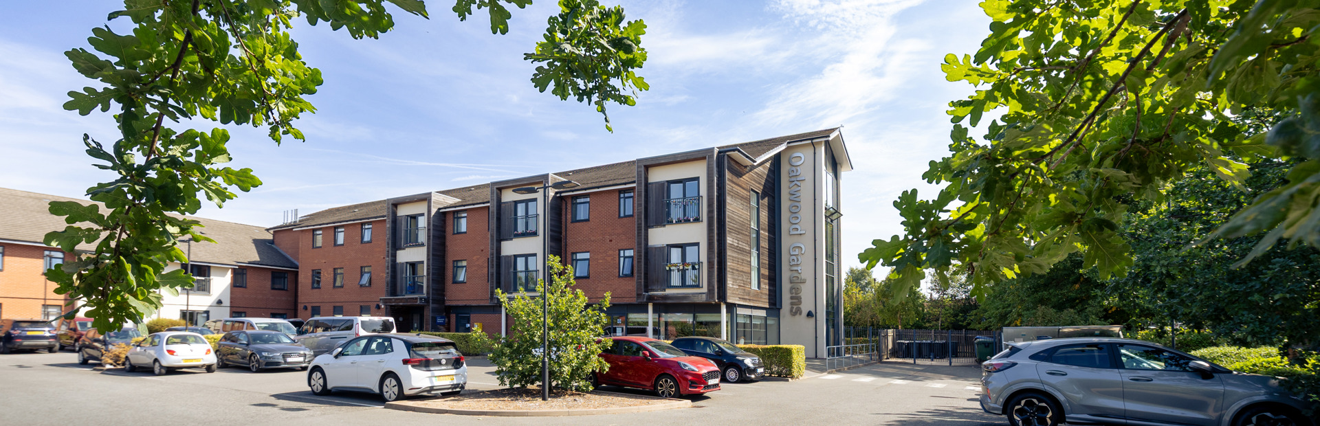 Front outer building of Oakwood Gardens with a car park situated at the front