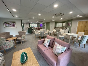 Cosy sofas, armchairs, coffee tables and seating areas in a modern communal living room