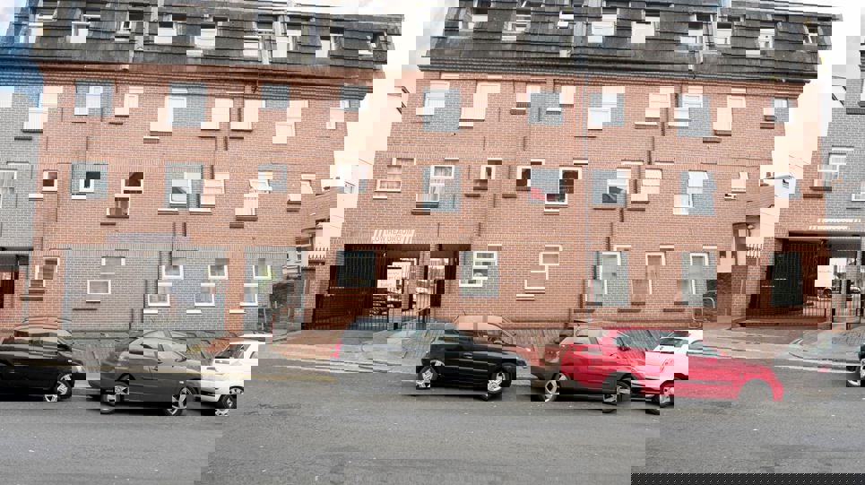 Gated entrance to the communal carpark behind the scheme