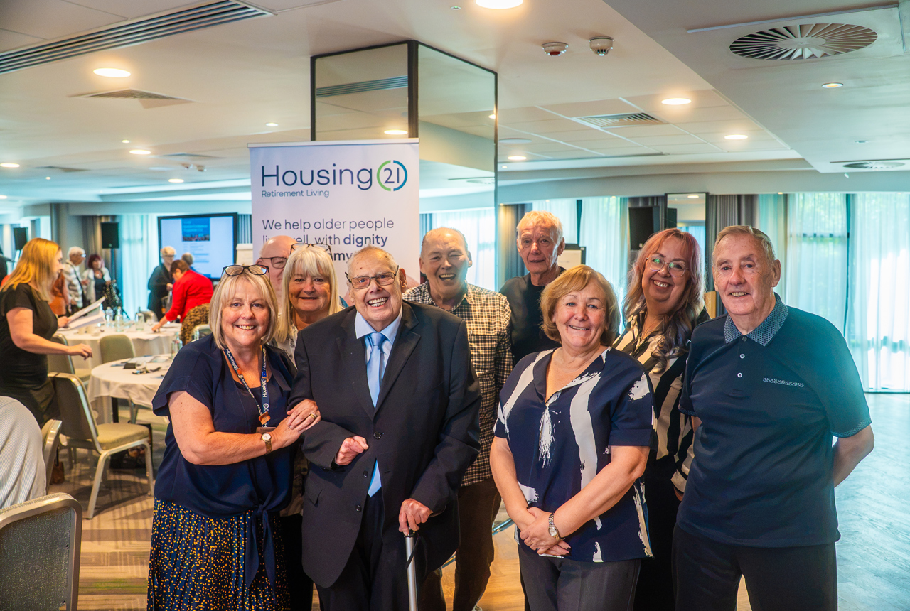 Group of residents smiling at the Manchester resident conference