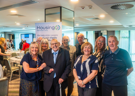 Group of residents smiling at the Manchester resident conference