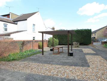Veranda over a large slabbed area outside of the scheme