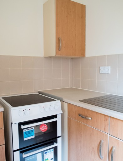 Small section of kitchen with sink area, worktops and oven