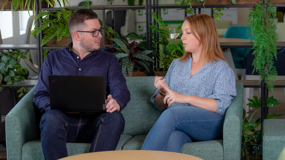 Corporate employees sitting down talking