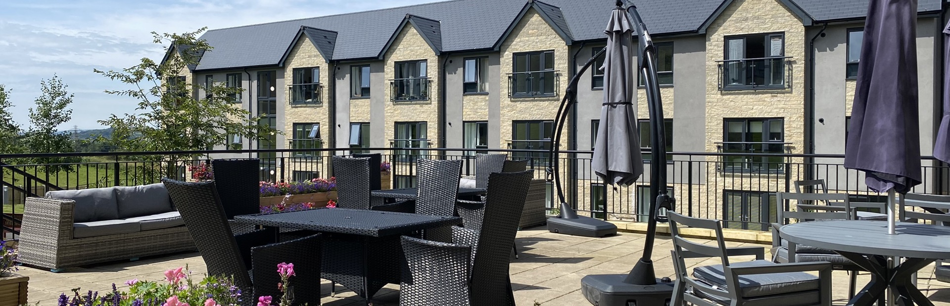 A photo of the large patio area at Castlestead View overlooking the garden on a sunny day