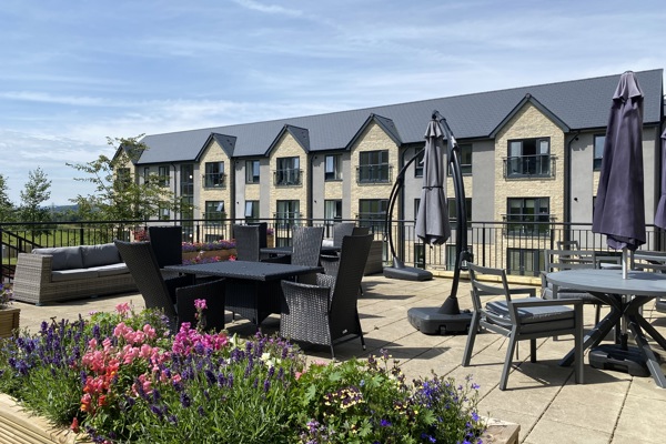 A photo of the large patio area at Castlestead View overlooking the garden on a sunny day