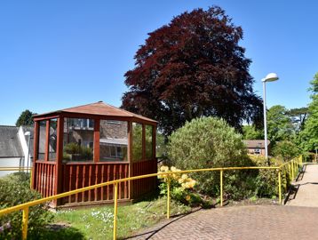Wooden veranda in the communal area outside of the scheme