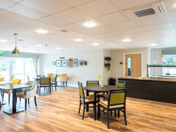 Communal cafe/ bistro with seating, tables and serving counter