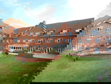 Large garden with a walled seating area and conservatory to the rear of the scheme