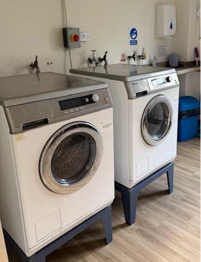 Two washing machines in a laundry room 