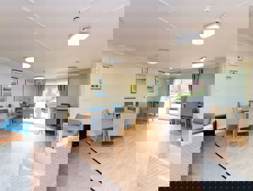 Tables and chairs in a communal room for residents