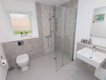A photo of a bathroom with accessible showering facilities at Castlestead View