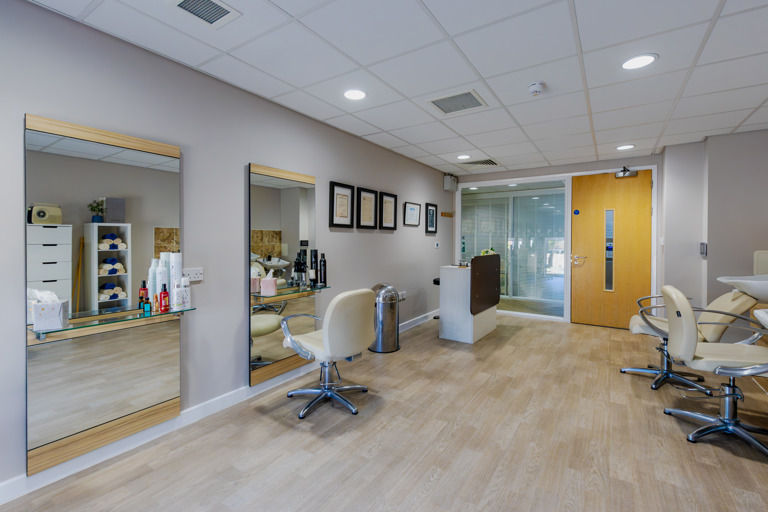 Inside the hair salon at Oakwood Gardens. Featuring large mirrors, chairs and sinks