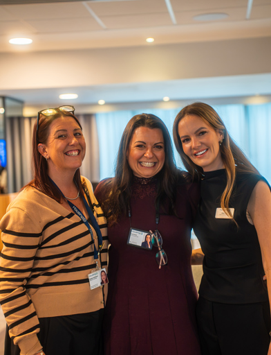 Three ladies standing and smiling 