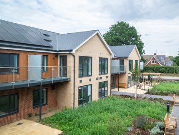 Rear of the building looking at patio and benches