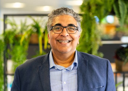 A photo of Respect and Inclusion Partner, Tahir Idris, smiling to camera