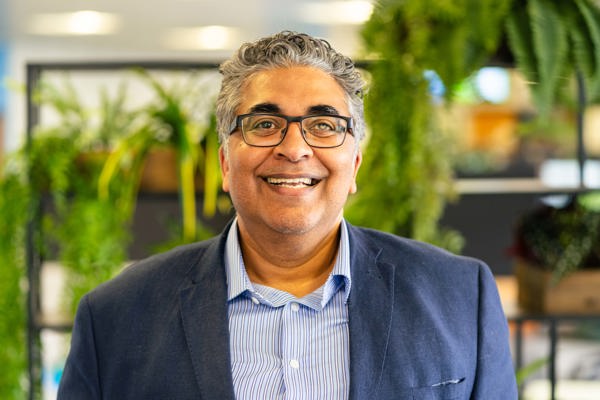 A photo of Respect and Inclusion Partner, Tahir Idris, smiling to camera