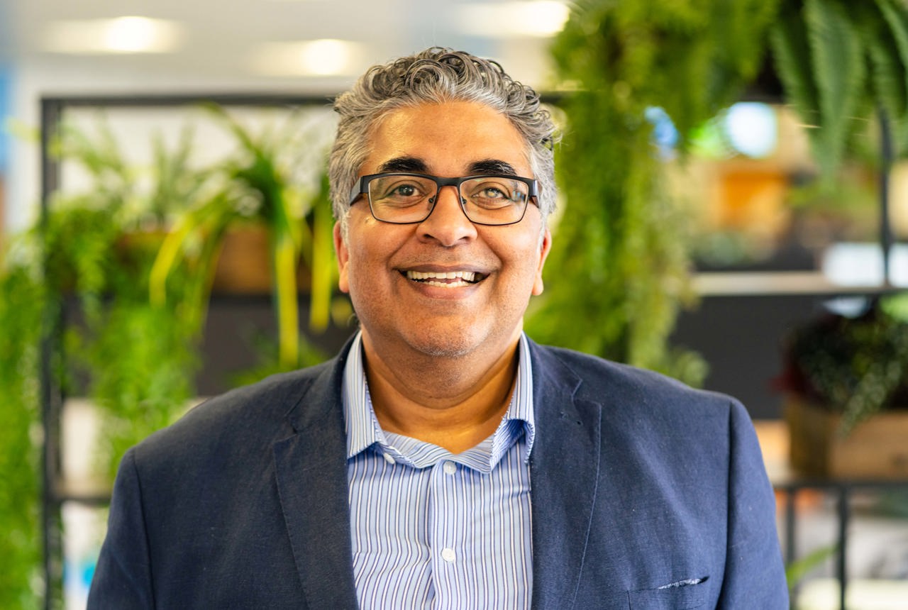 A photo of Respect and Inclusion Partner, Tahir Idris, smiling to camera
