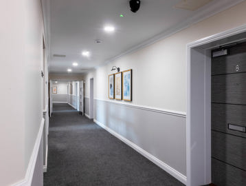 Communal corridor with modern grey doors into the apartments