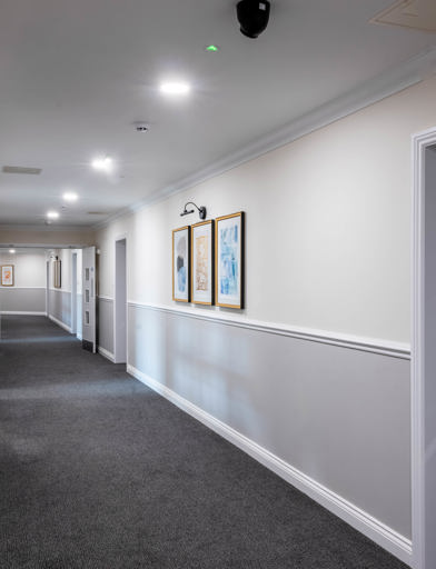 Communal corridor with modern grey doors into the apartments 