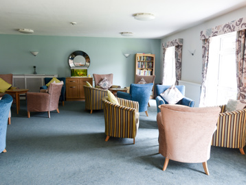 Soft seating and coffee tables in the residents' lounge