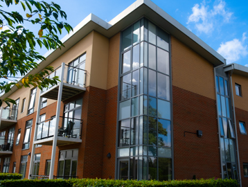 A view of the corner of the main building on a bright day with blue sky