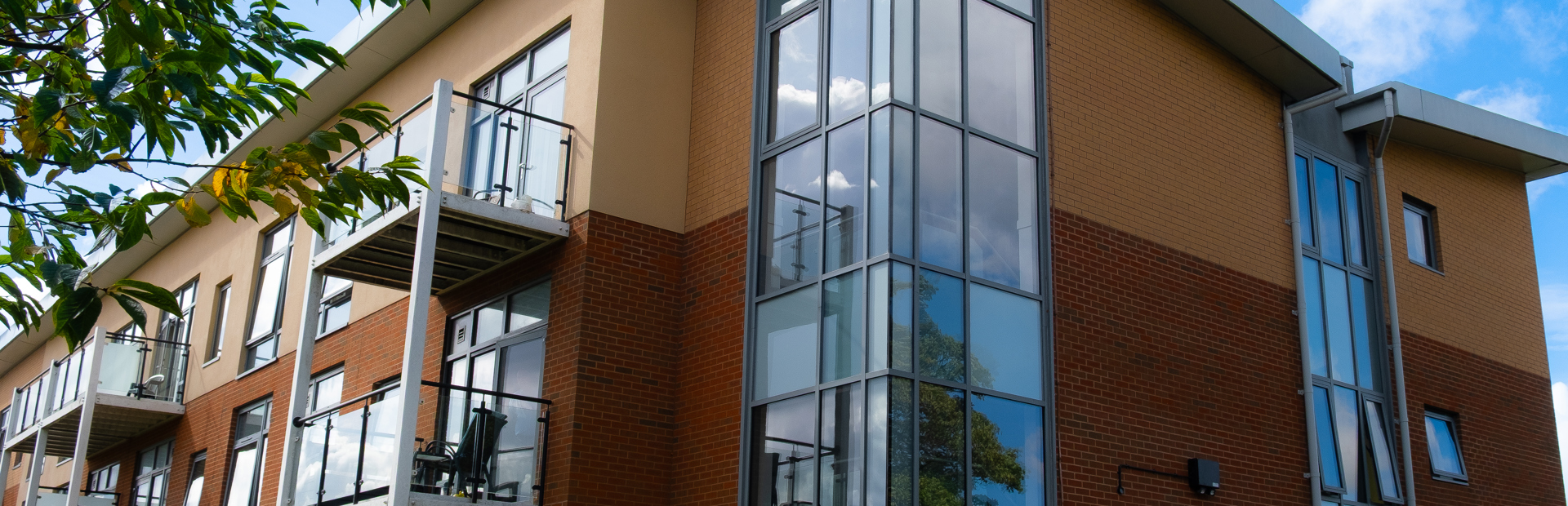 A view of the corner of the main building on a bright day with blue sky