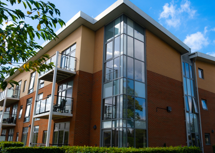 A view of the corner of the main building on a bright day with blue sky