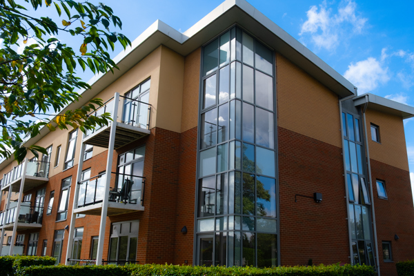 A view of the corner of the main building on a bright day with blue sky