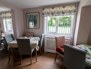 Communal dining area with tables and chairs