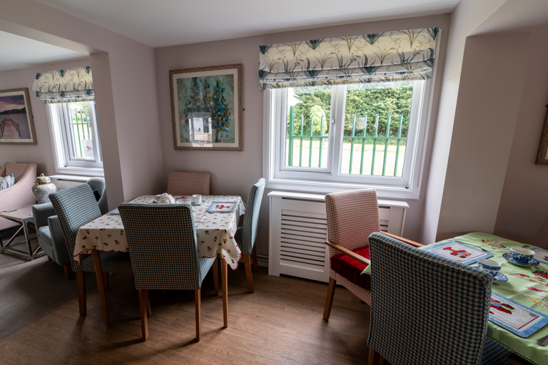 Communal dining area with tables and chairs
