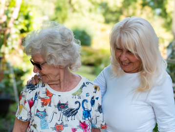 A mother and daughter enjoying the communal gardens at St Crispin